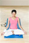 Young woman sitting in a lotus position