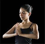 Close-up of a young woman in a prayer position