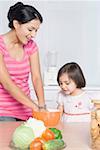 Girl looking at her mother preparing food