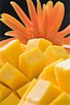 Close-up of mango slices with daisy flower