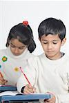 Boy and girl sitting in a classroom and studying