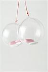 Pair of glass ornaments containing candy, close-up