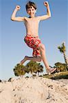 Boy Jumping on the Beach