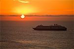 Cruise ship on pacific ocean at sunrise
