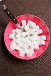 A bowl of sugar cubes and a spoon