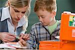 Teacher and boy with plaster on finger