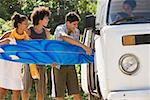 Teenagers loading a camper van