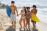 Teenagers walking along a beach