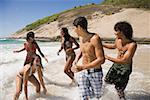 Teenagers fooling around on the beach