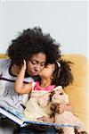 A girl kissing her mother on the cheek