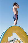 Boy Standing on Slide