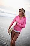 Surfer Standing on the Beach at Dusk, Encinitas, San Diego County California, USA