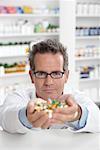 Portrait of Pharmacist With Handful of Pills