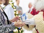 Santa Claus Man Giving Christmas Present to Woman