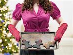 Woman Holding Tray of Burnt Christmas Cookies