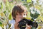 Boy Looking Through Binoculars, Elmvale, Ontario, Canada