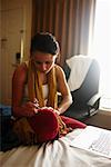 Woman Applying Nail Polish in Hotel Room