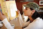 Woman Looking at Restaurant Menu