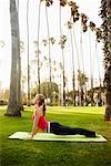 Woman Practicing Yoga in Park, Santa Monica, California, USA