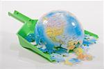 Close-up of a broken globe on a dustpan