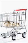 Close-up of three golden eggs in a shopping cart