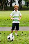 Portrait of a boy playing soccer in a park