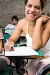 Portrait of a teenage girl smiling in a classroom