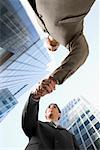 Low angle view of two businessmen shaking hands