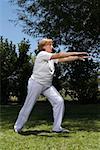 Senior woman exercising in a garden