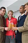 Four business executives toasting with glasses of beer in a party