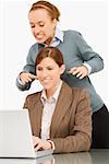 Businesswoman working on a laptop with her colleague try to strangle behind her