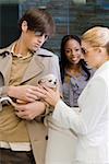 Young man and a young woman looking at a puppy