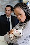 Close-up of a young woman holding a puppy