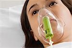 Close-up of a female patient wearing an oxygen mask