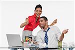 Businesswoman and a businessman dancing together in an office