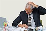 Businessman sitting at a desk in an office and smiling