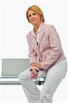 Portrait of a businesswoman sitting on a table