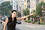 Businesswoman hailing for a vehicle