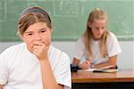 Close-up of a schoolgirl thinking in a classroom