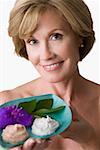 Portrait of a mature woman holding a bowl and smiling