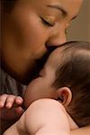 Close-up of a young woman kissing her son