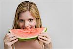 Portrait of a teenage girl eating a slice of watermelon