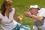 Senior couple holding glasses of juice and smiling