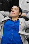 High angle view of a businesswoman sleeping at an airport