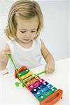 Toddler girl playing xylophone, high angle view