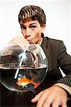 Businessman Drinking From a Fishbowl