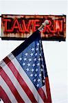 American Flag in Front of Tavern Sign