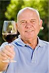 Portrait of Man Raising Glass of Red Wine
