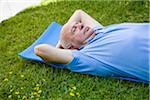 Man Lying on Exercise Mat Outdoors