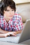 Boy looking into laptop